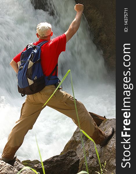 Man on the brink of raging falls,with a backpack. Man on the brink of raging falls,with a backpack