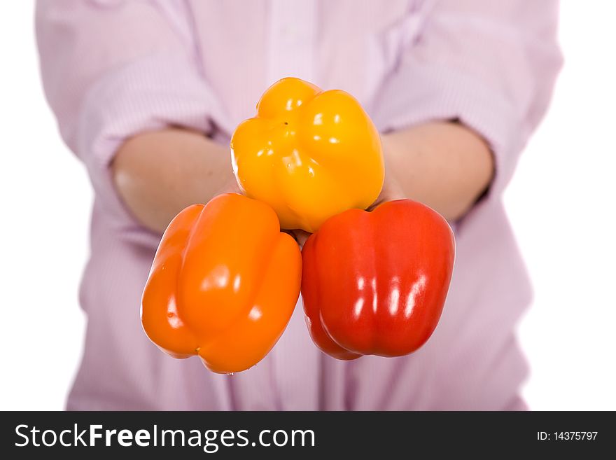 Woman holds three peppers, orange, red and yellow, all isolated on white. Woman holds three peppers, orange, red and yellow, all isolated on white