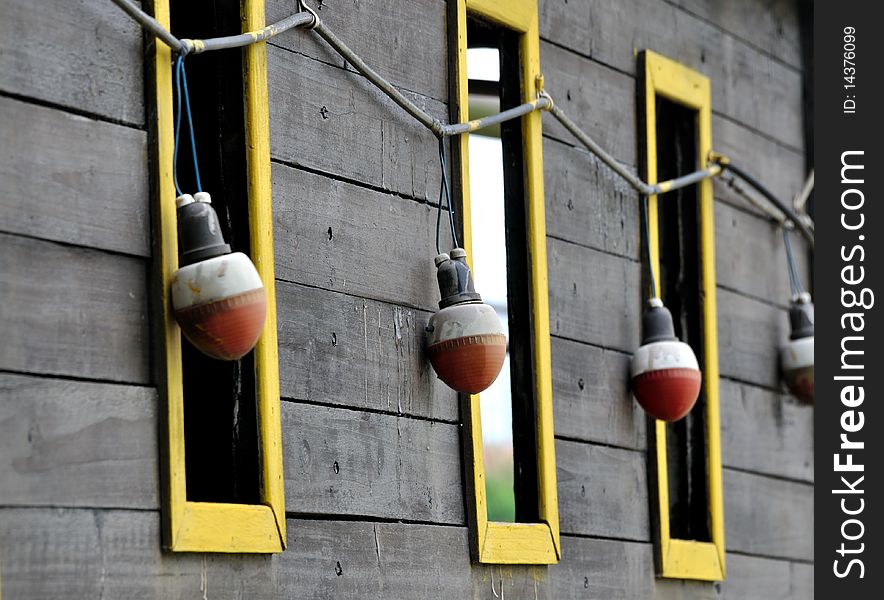 Windows and red bulb on wooden wall