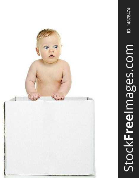 Eight month baby holds on to the white box. Eight month baby holds on to the white box