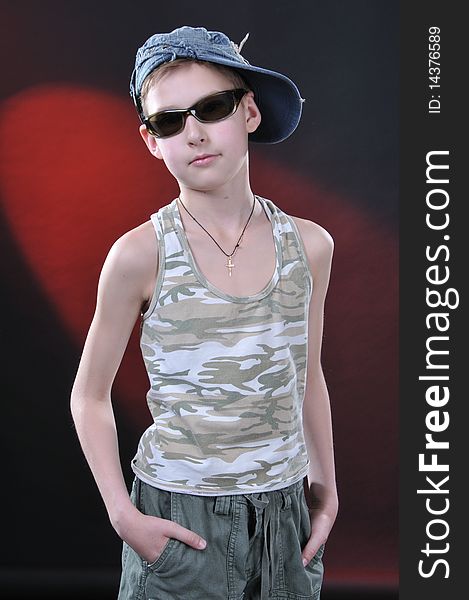 Portrait of is ten years old boy in a jean cap and sun glasses