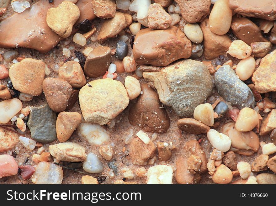 River rocks in a bed of sand. River rocks in a bed of sand.