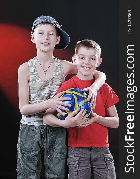 Portrait of two laughing boys of ten years with a ball in hands. Portrait of two laughing boys of ten years with a ball in hands