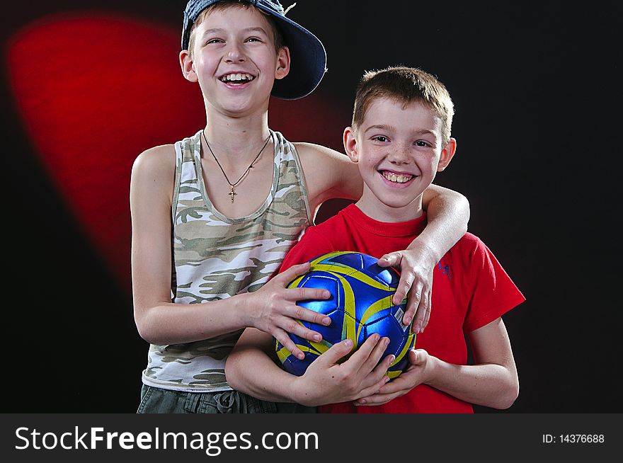 Portrait of two laughing boys of ten years with a ball in hands. Portrait of two laughing boys of ten years with a ball in hands