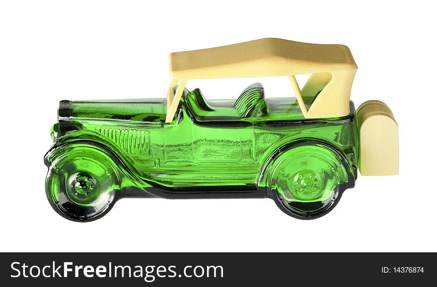 An antique small green glass car ornament which is fast but fragile, on isolated white background