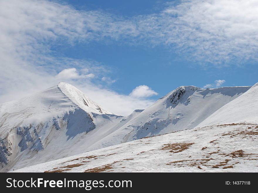 Winter mountain top in a landscape with a white slope. Winter mountain top in a landscape with a white slope