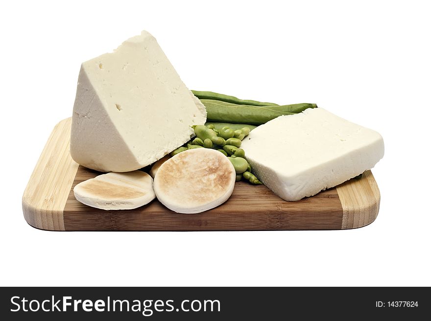 Beans and cheese on a cutting board is a white background. Beans and cheese on a cutting board is a white background