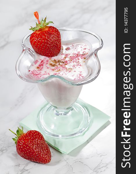 Milk shake with fresh strawberries on white table top. Milk shake with fresh strawberries on white table top