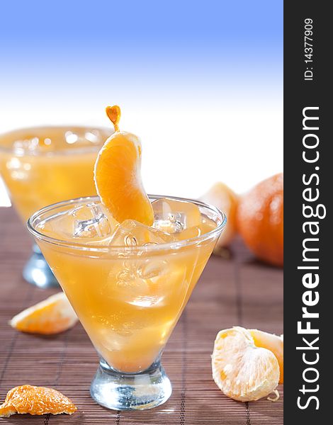 Glass of ice cold beverage with tangerine fruits. Glass of ice cold beverage with tangerine fruits