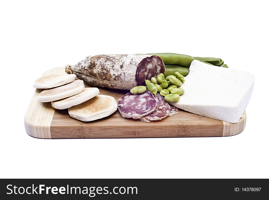Beans sausage and cheese on a cutting board is a white background. Beans sausage and cheese on a cutting board is a white background