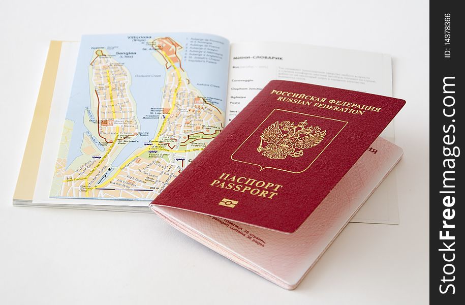 The Russian passport lies on the open guidebook. The Russian passport lies on the open guidebook