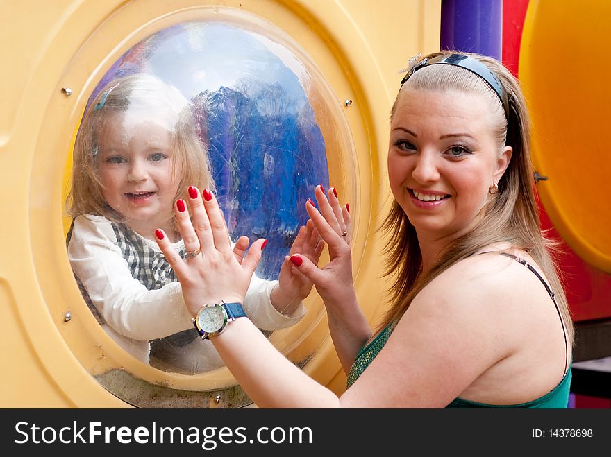 Mother and daughter in playground equipment. Mother and daughter in playground equipment