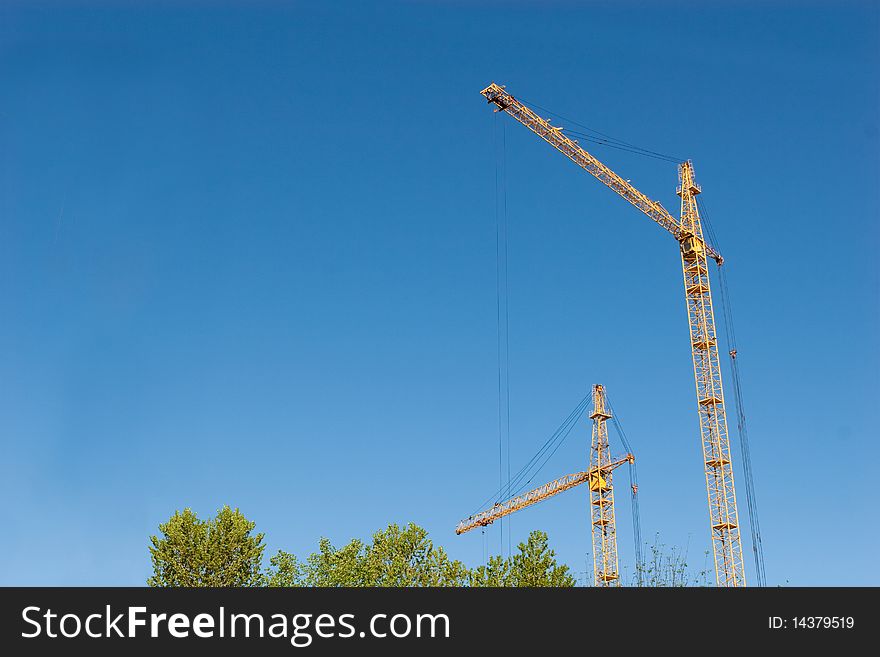 Two hoisting cranes and the sky