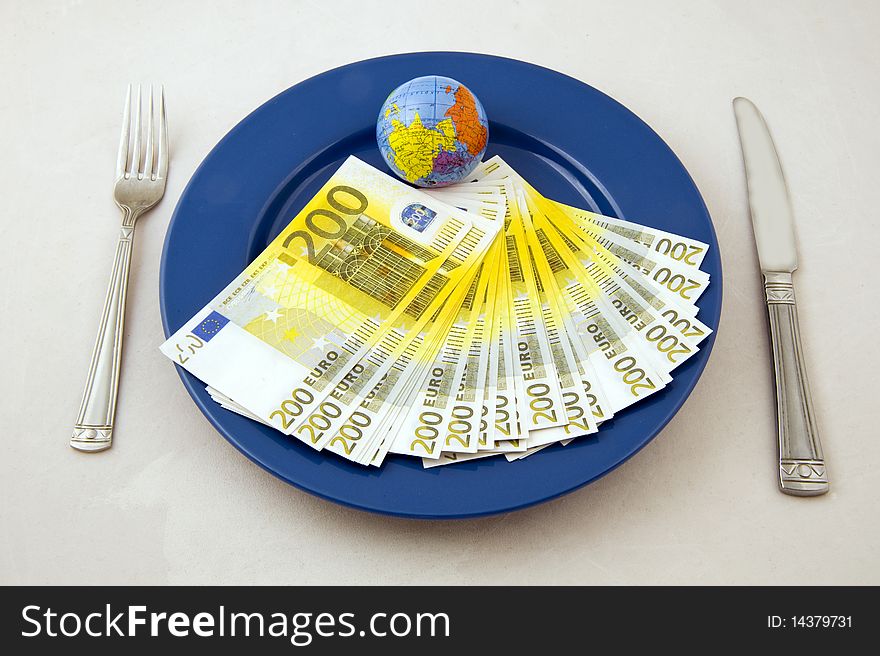 Euro money an small globe on the plate. Euro money an small globe on the plate