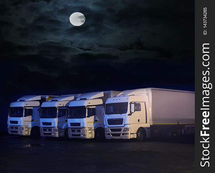 Big trucks at night in parking lot