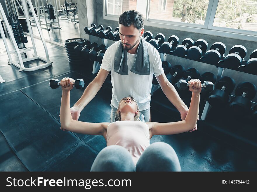 Beautiful Woman in Fitness Club and Trainer With Dumbbells Equipment, Portrait of Couple Love an Exercising Muscular Training in