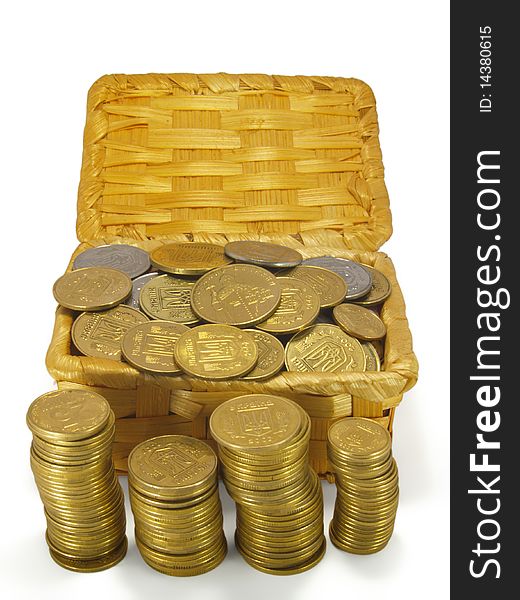 Coins in a wicker trunk, and in columns, isolated