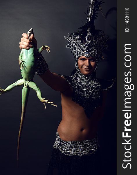 Pagan Priest In Ritual Suit With Green Iguana