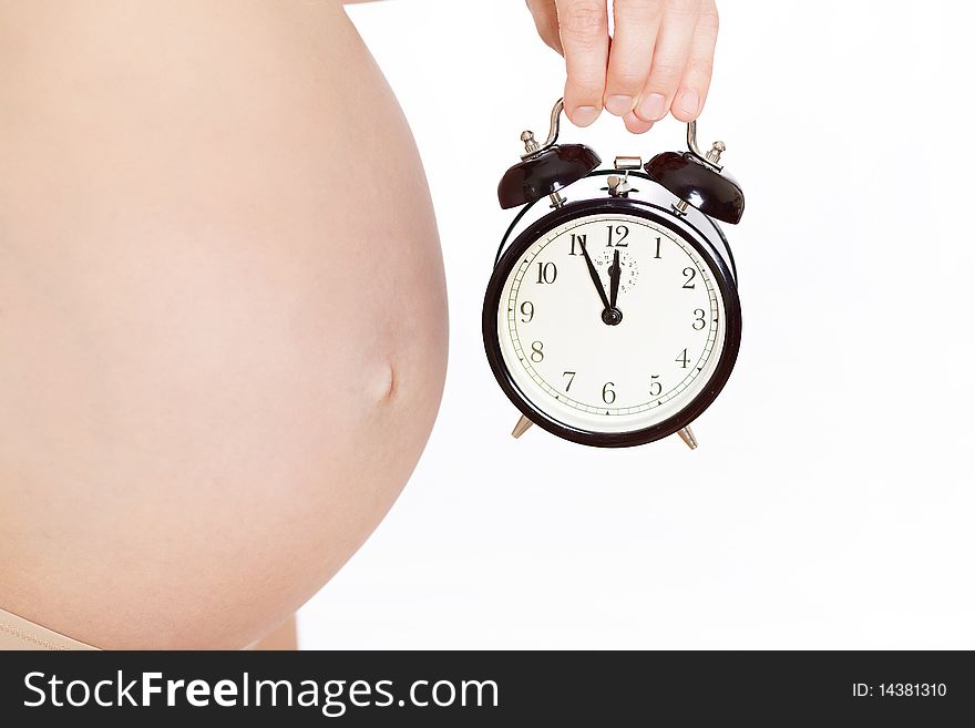 It's time! Pregnant woman's belly with clock