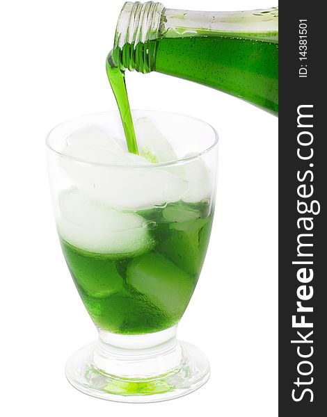 Green fruit juice in a glass with ice