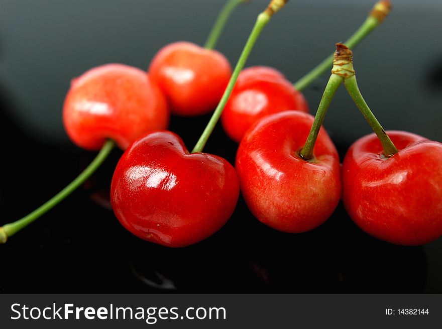 Fresh red cherry fruits isolated on a blurred background