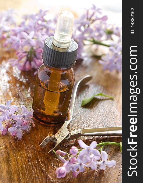 Massage oil for nail and manicure scissors. Lilac on background. Could be a generic toiletry. Massage oil for nail and manicure scissors. Lilac on background. Could be a generic toiletry.