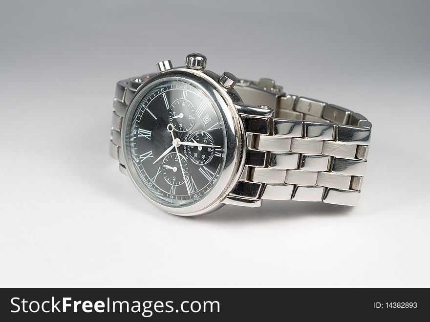 Used silver watch on gray background