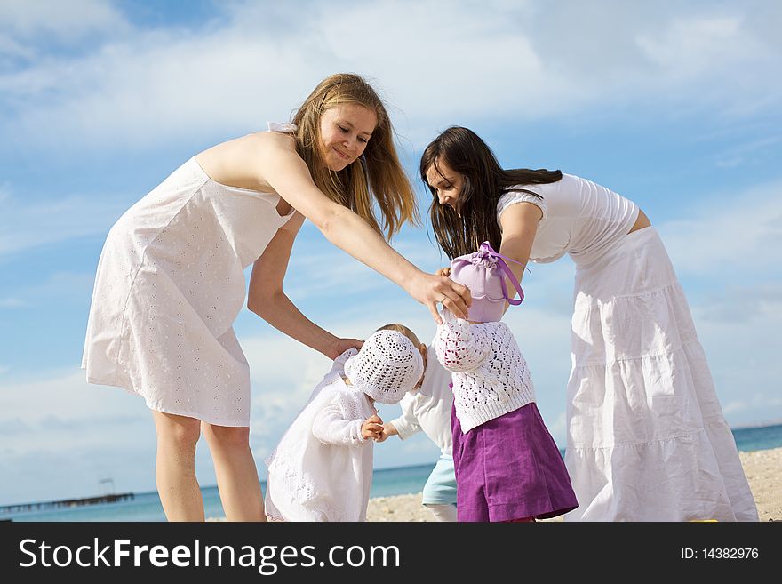 Happy mothers with children at the beach on leave