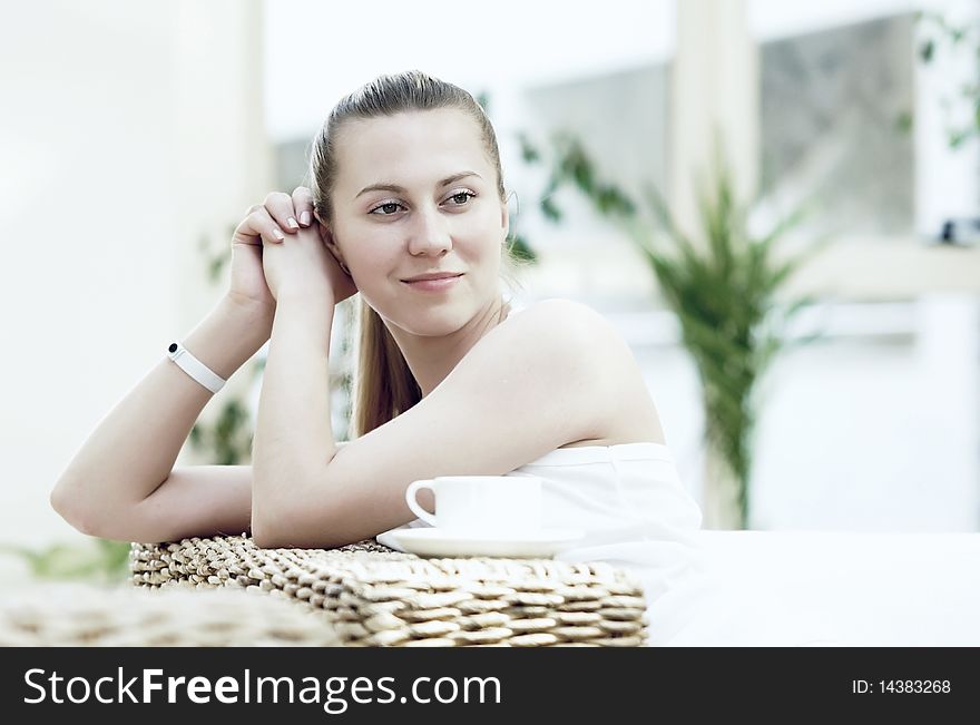 Happy young woman in white at home