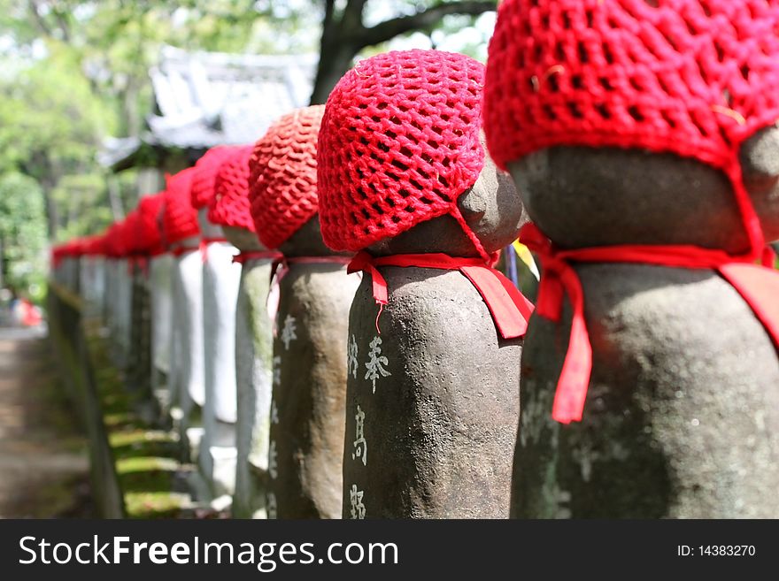 Figure of Buddha doll Japan religion red hat shrine