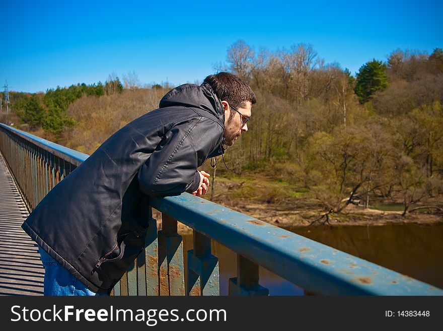 Man Standing On A Bridge