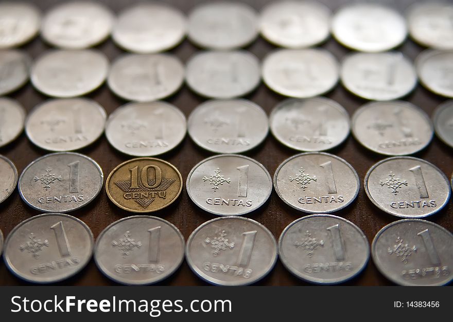 Close-up background made of lithuanian coins, one of them is different from the other. Close-up background made of lithuanian coins, one of them is different from the other