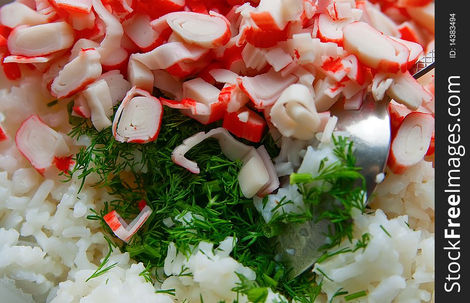 Close-up tasty salad with crab sticks, rice and dill. Close-up tasty salad with crab sticks, rice and dill