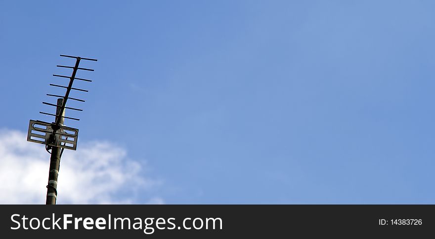 A Metal Television aerial against a blue sky. A Metal Television aerial against a blue sky.