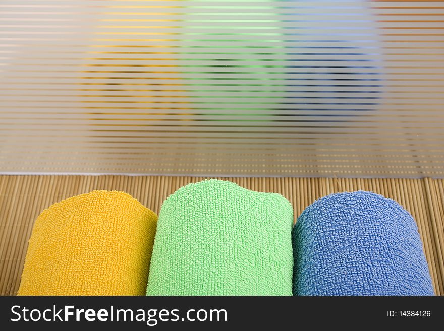 Colored towels are folded to lie near. reflection. Colored towels are folded to lie near. reflection