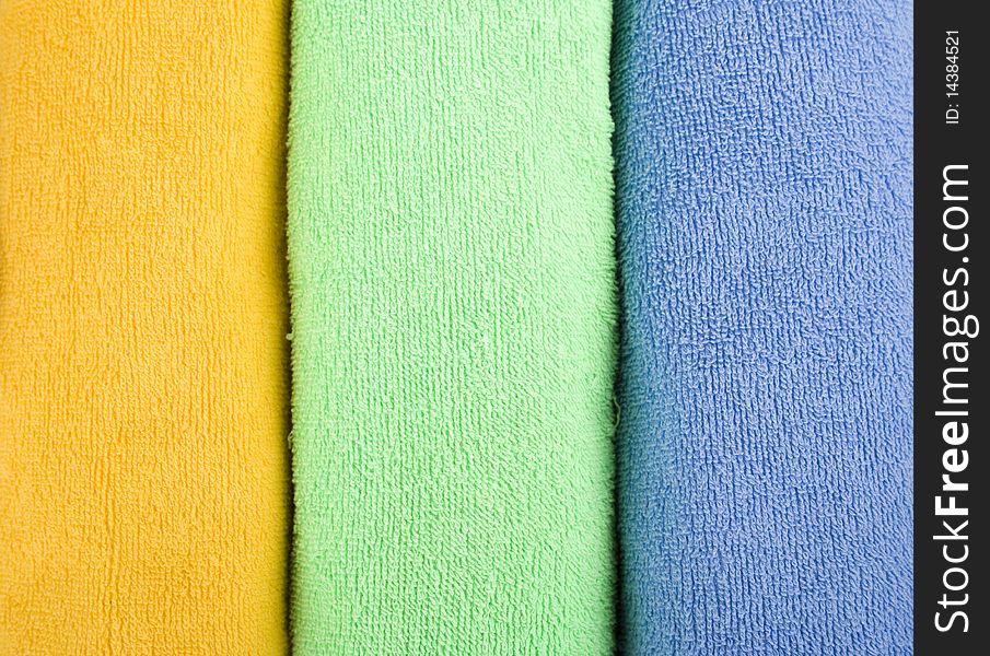 Colored towels are folded to lie near. reflection. Colored towels are folded to lie near. reflection