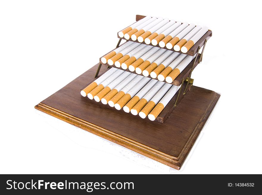 It is a lot of cigarettes on a support on a white background