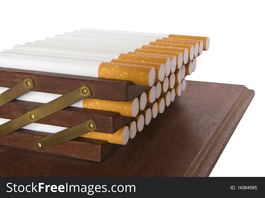 It is a lot of cigarettes on a support on a white background