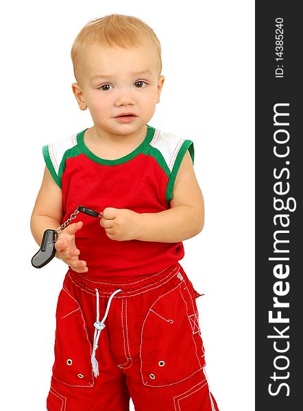 Little boy holding in hands car key on white background