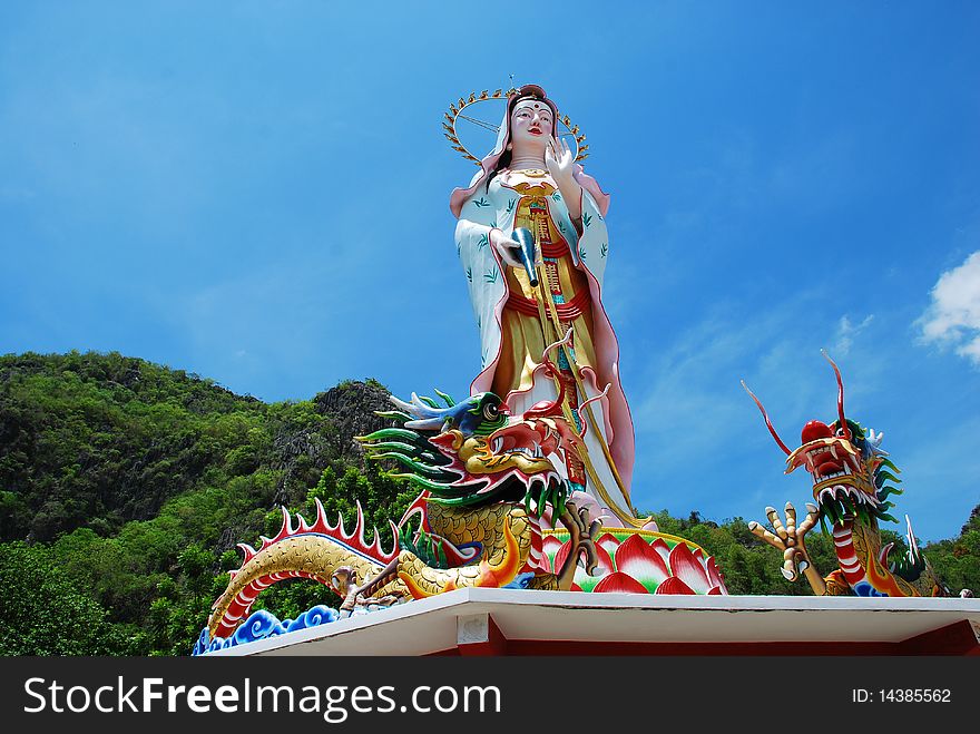 Chinese Guan Yin Buddha on dragons in the mountain.