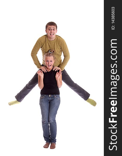 Boy jump in air, his girlfriend smiling, shot in studio on white background