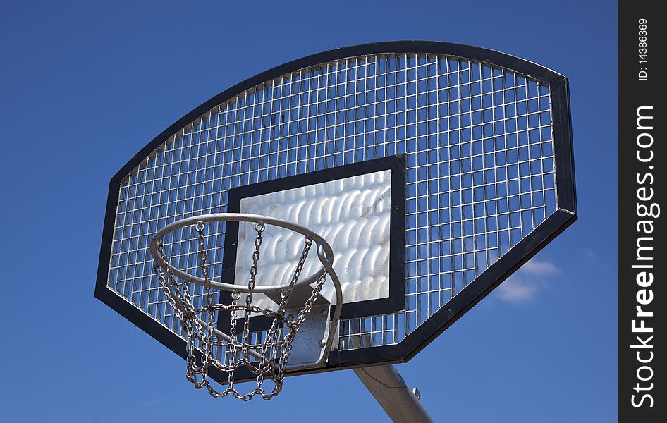 A basketball basket with blue sky