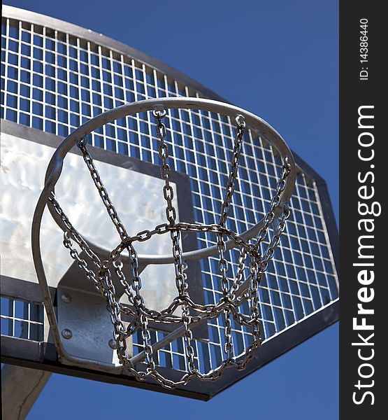 A basketball basket with blue sky