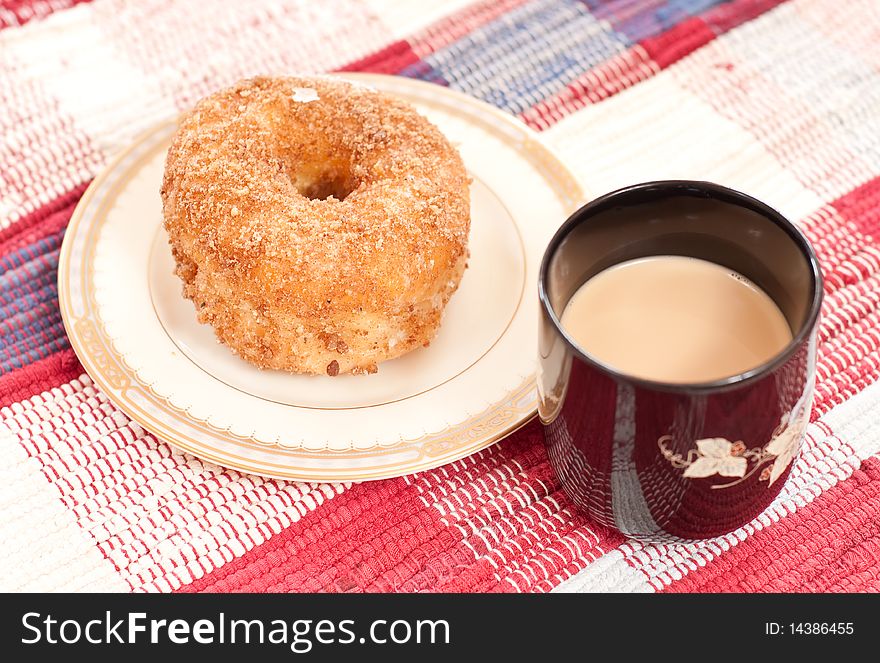 Single donut and coffee for a quick morning breakfast. Single donut and coffee for a quick morning breakfast