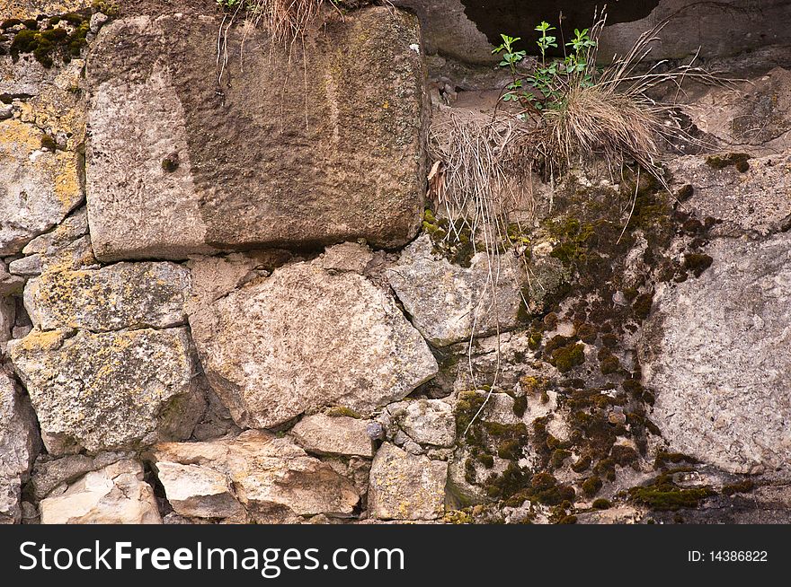 Old stone wall covered with a moss