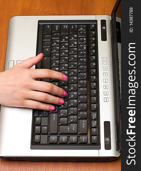 Female hand on the laptop keyboard. Female hand on the laptop keyboard.