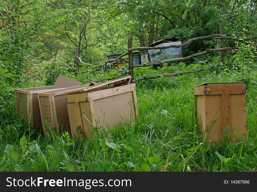 Several transporting beehives, lath fence, apiary