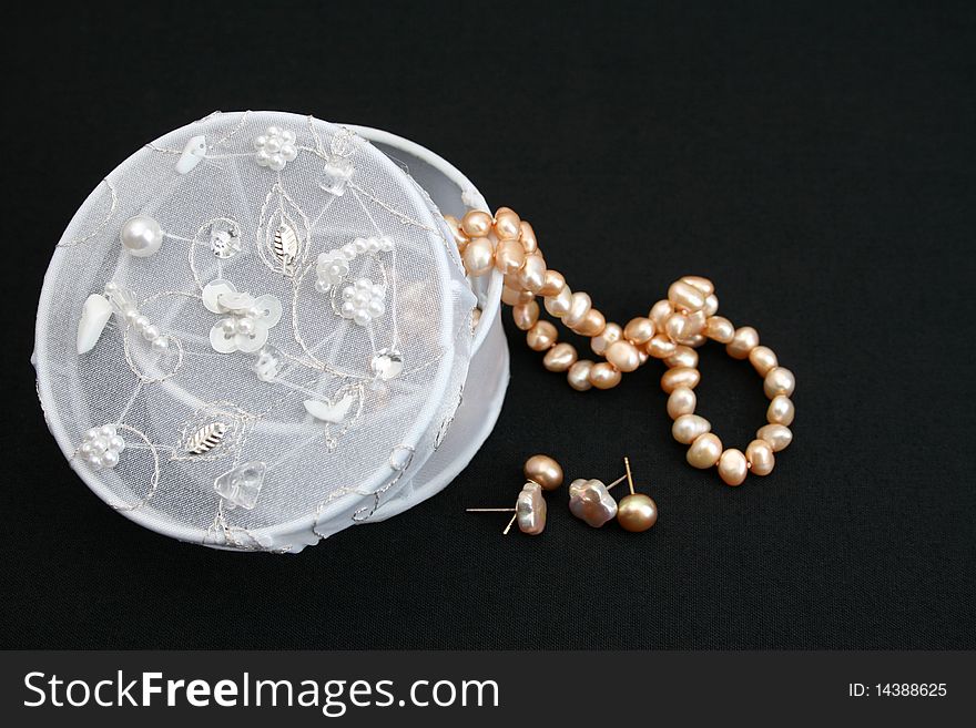 White embroidered jewelery box with a string of pearls. White embroidered jewelery box with a string of pearls