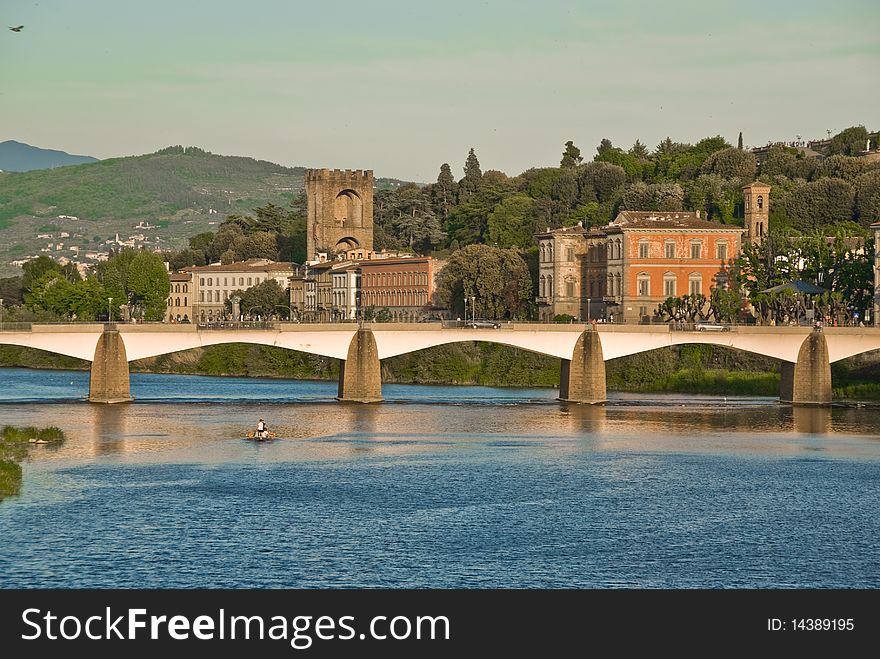 A bridge crossing over the Arno River, just behind the Ponte Vecchio bridge in Florence, Italy.