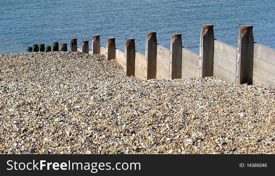 Photo of breakwater pebble beach and sea. Photo of breakwater pebble beach and sea.